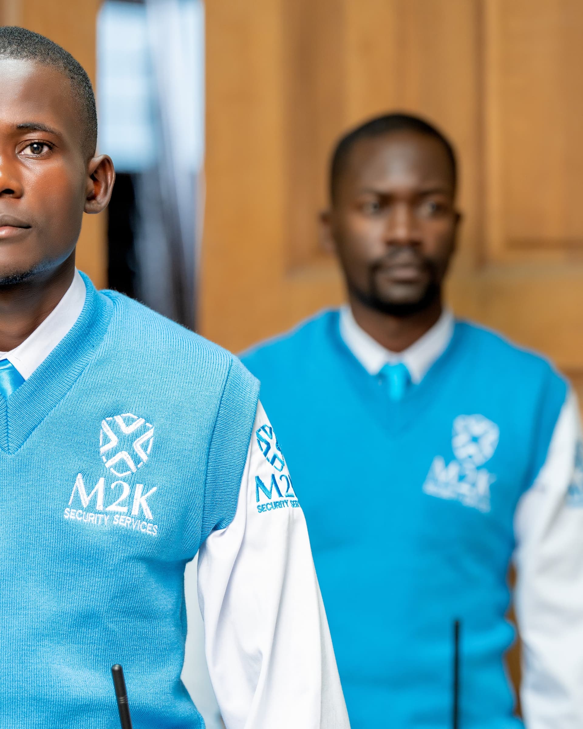 Close-up of M2K guards in branded sky blue uniform